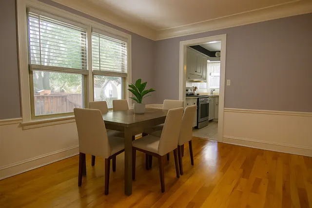 a view of a dining room with furniture and wooden floor