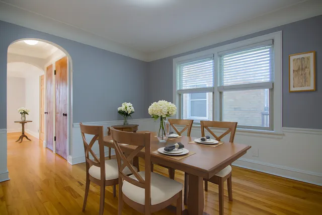 a view of a dining room with furniture and wooden floor