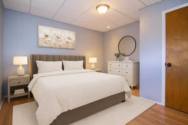 a bedroom with a bed and a chandelier