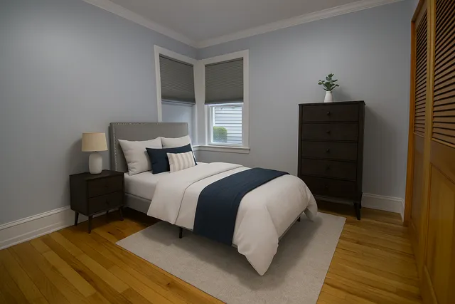 a bedroom with a bed and wooden floor