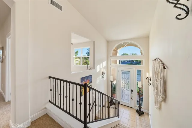 a view of a hallway with windows and entryway