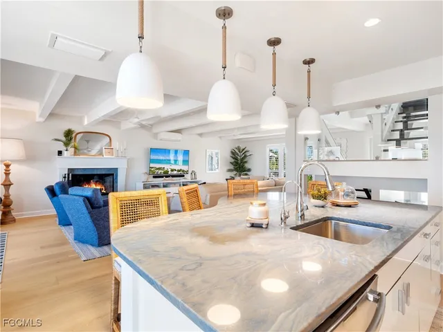 a bathroom with a granite countertop sink and a bathtub