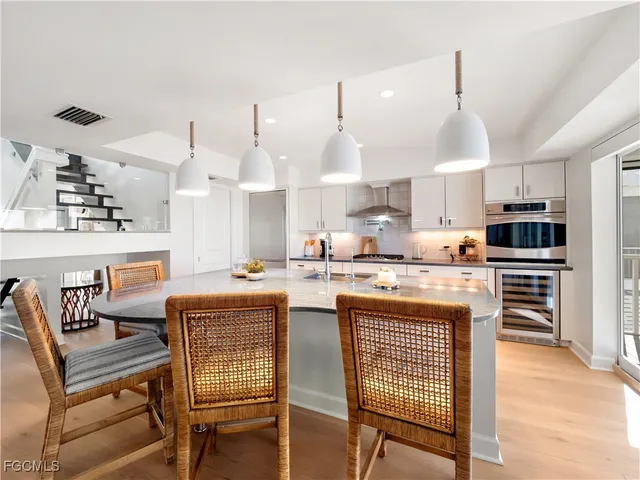 a bathroom with a granite countertop tub sink and mirror
