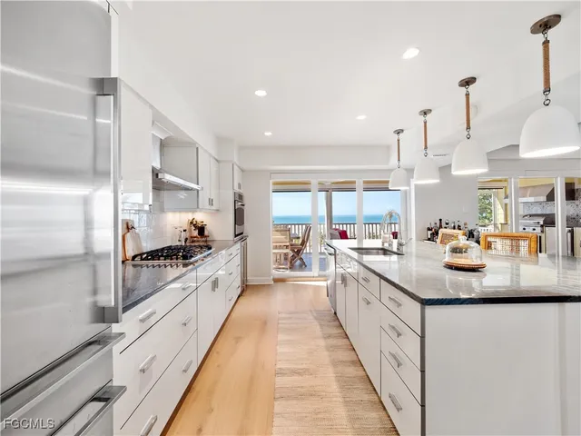 a bath room with a sink and a large mirror