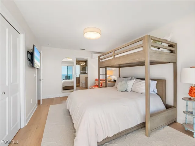 a bedroom with a large bed and a chandelier