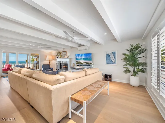 a living room with furniture a large window and a flat screen tv