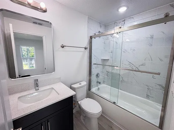a bathroom with a sink toilet and shower