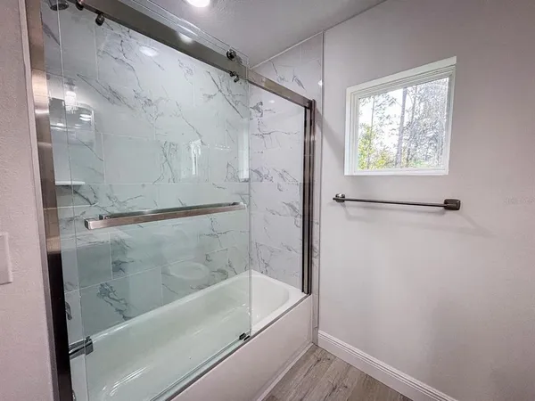 a bathroom with a bathtub and a shower