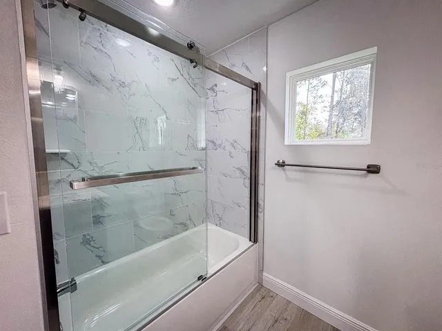 a bathroom with a bathtub and a shower