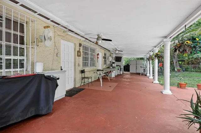 a view of a patio with table and chairs with wooden floor and fence