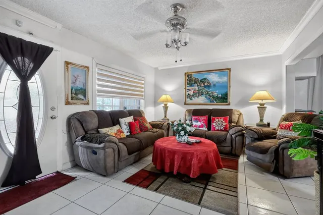 a living room with furniture a rug and a window