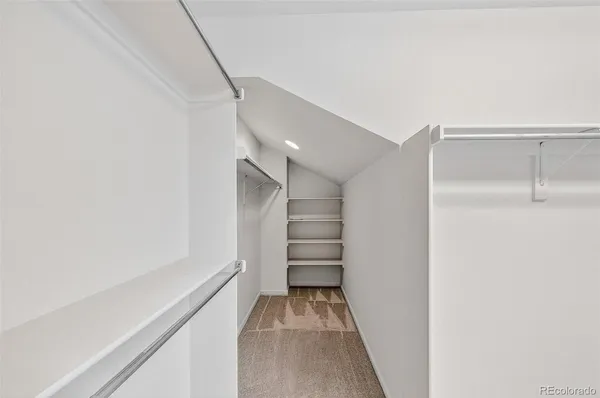 a view of an empty room and a ceiling fan