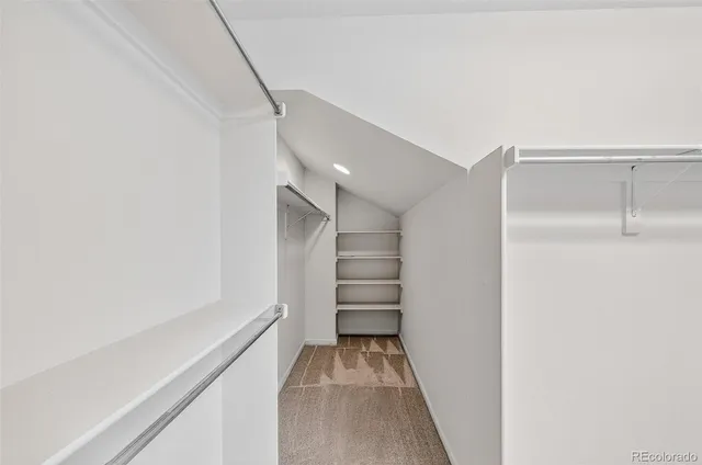 a view of an empty room and a ceiling fan