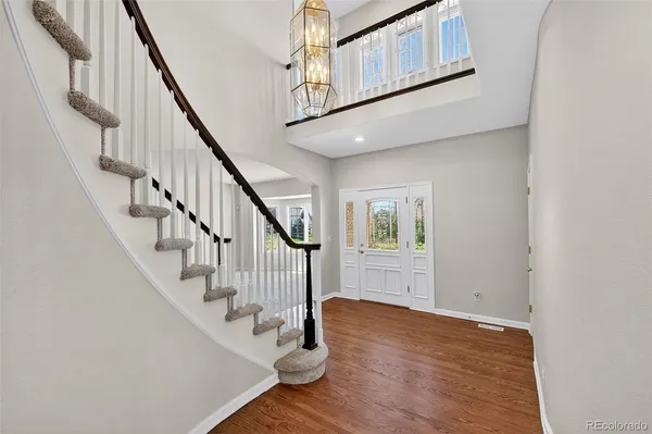 a view of entryway and hall with wooden floor