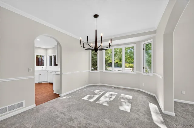 a view of a room with window and chandelier