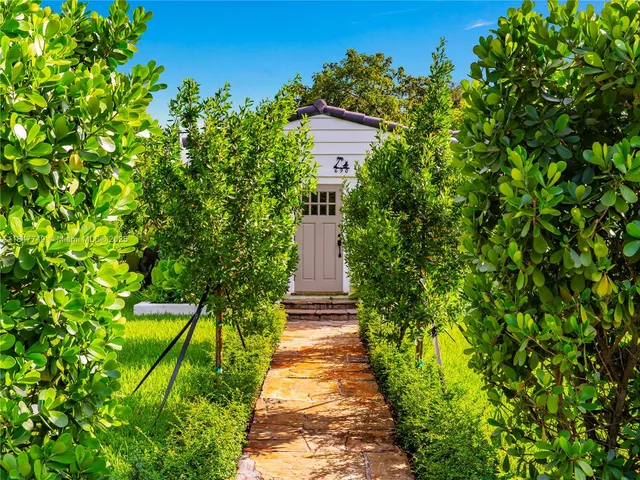 a pathway of a house with a yard