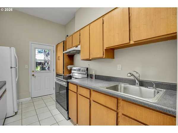 a view of a white house with a yard