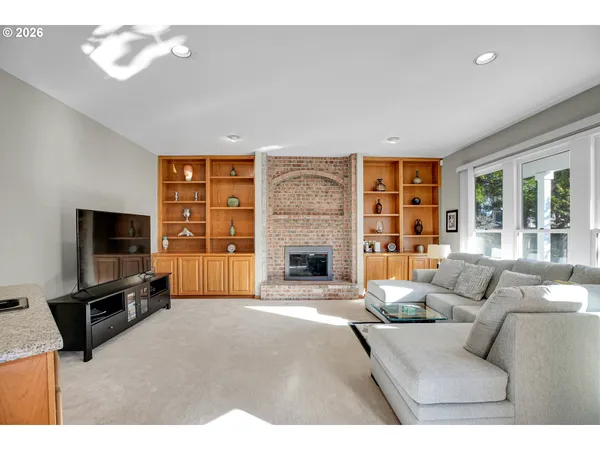 a living room with furniture a fireplace and a flat screen tv