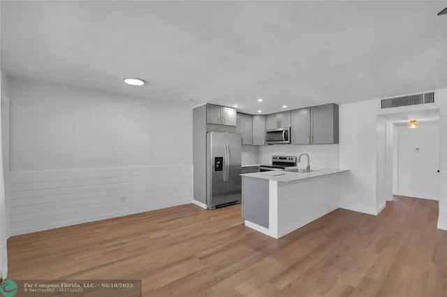a view of kitchen with wooden floor