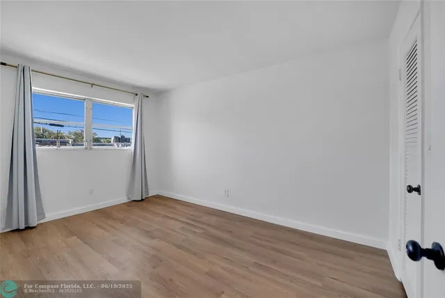 a view of a room with wooden floor