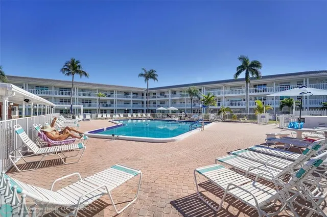 a view of a rooftop deck with couch and chairs