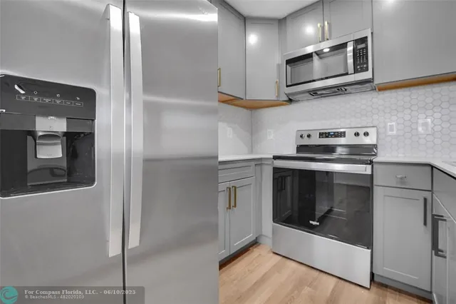 a kitchen with stainless steel appliances granite countertop a stove and a refrigerator