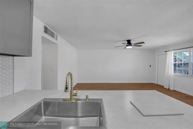 a kitchen with a sink and a window