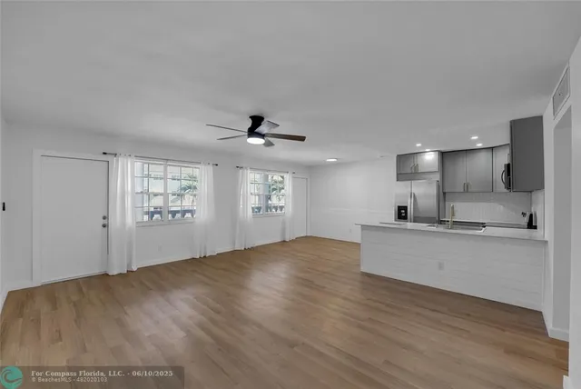 a view of kitchen with sink and wooden floor