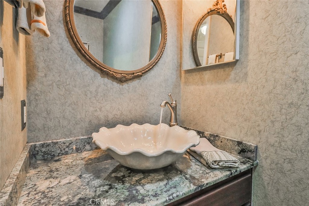 240 Portal Street Oak View, CA 93022 - Photo 40 of 75 a bathroom with a granite countertop sink and a mirror