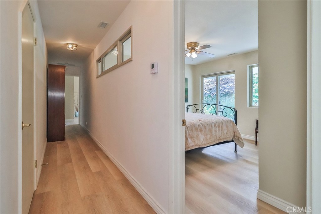 240 Portal Street Oak View, CA 93022 - Photo 54 of 75 a bedroom with a bed and a chandelier