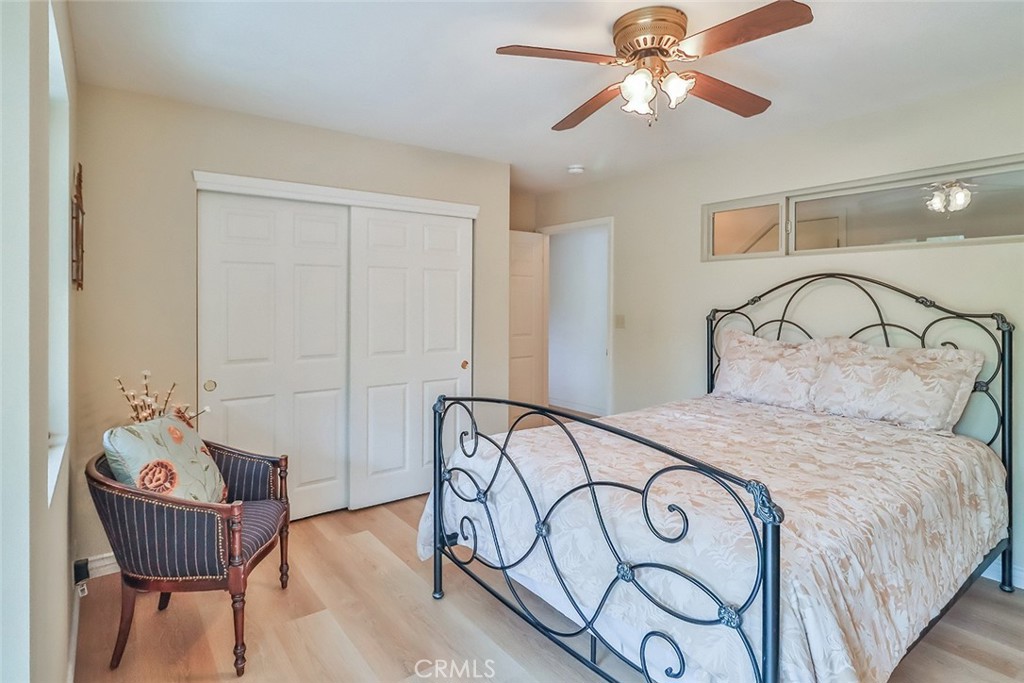 240 Portal Street Oak View, CA 93022 - Photo 56 of 75 a bedroom with a bed and a chandelier