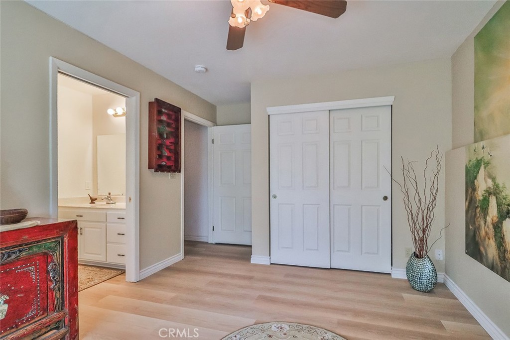 240 Portal Street Oak View, CA 93022 - Photo 59 of 75 a view of a livingroom with wooden floor and a ceiling fan