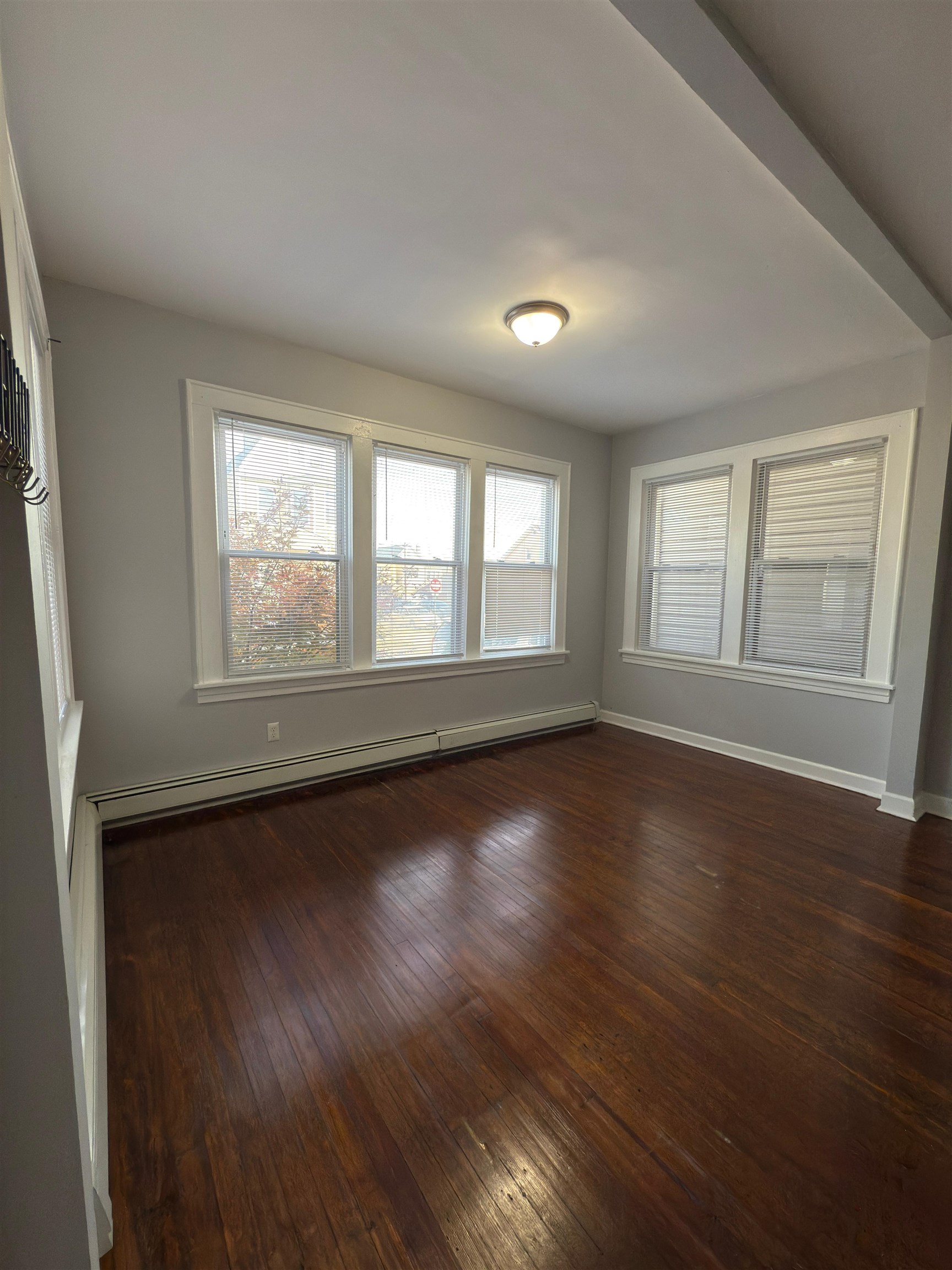 275 Highland Avenue, Unit 1 Kearny, NJ 07032 - Photo 6 of 8 an empty room with wooden floor and windows