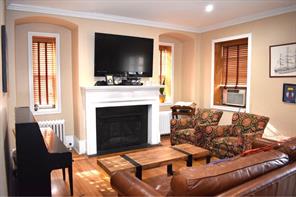 828 Bronx River Road, Unit 1CD Bronxville, NY 10708 - Photo 1 of 1 a living room with furniture a flat screen tv and a fireplace