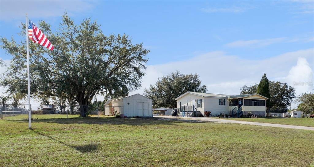 a front view of house with yard and trees