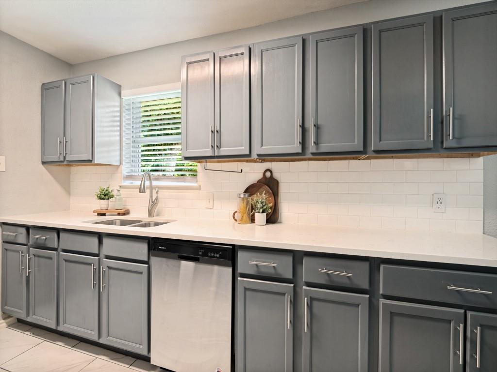 1405 Rambler Road Arlington, TX 76014 - Photo 13 of 26 Updated kitchen featuring gray shaker-style cabinetry, white subway tile backsplash, and light-toned countertops
