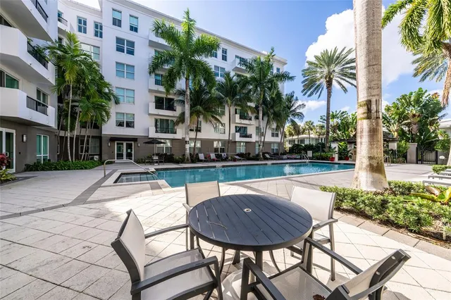 a swimming pool with outdoor seating and yard