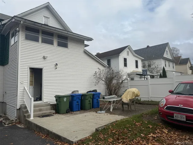 a view of a chairs and table in the back yard of the house
