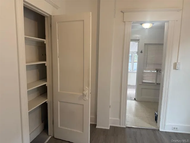 a view of walk in closet with empty racks