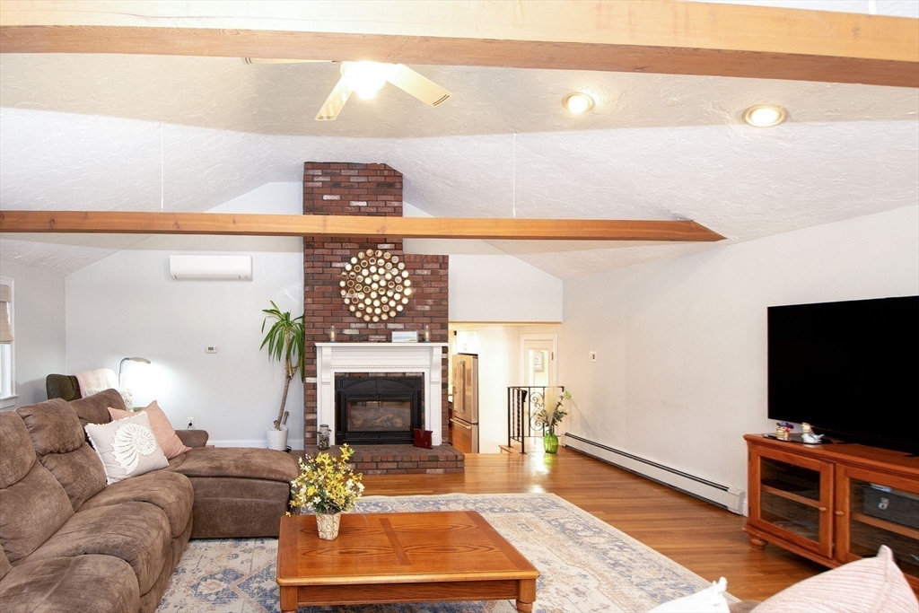 18 Longmeadow Road Scituate, MA 02066 - Photo 14 of 37 a living room with furniture and a fireplace
