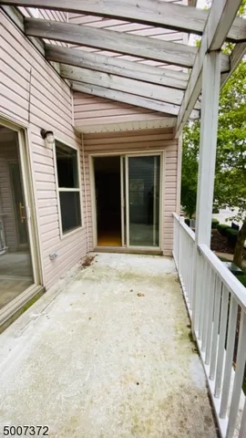 a view of staircase with wooden floor and next to a window