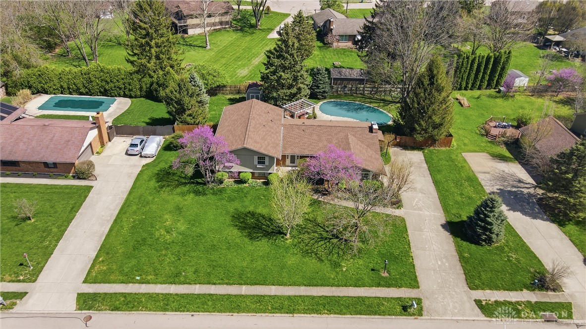 9964 Hummingbird Way Dayton, OH 45458 - Photo 2 of 57 This spacious property offers a refreshing pool and ample green space for outdoor enjoyment.