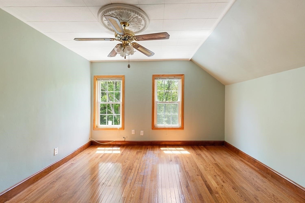 19 Butler Avenue Wakefield, MA 01880 - Photo 22 of 33 an empty room with wooden floor chandelier fan and windows