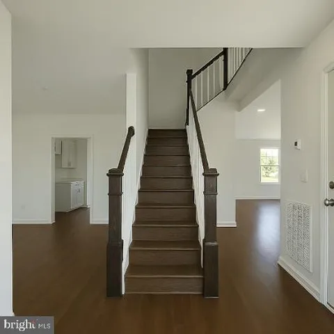 a view of entryway and hall with wooden floor