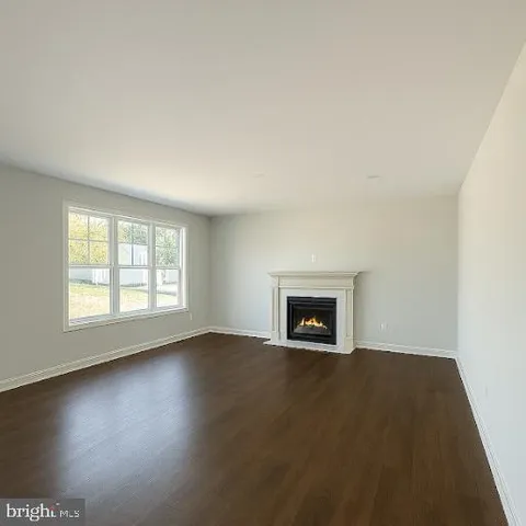 an empty room with a fireplace and window