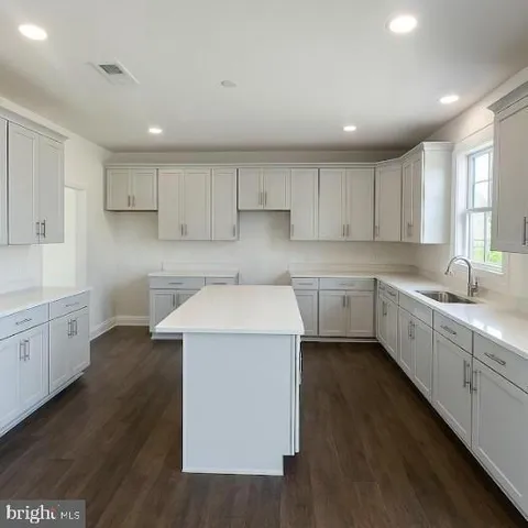 a kitchen with a sink window and cabinets