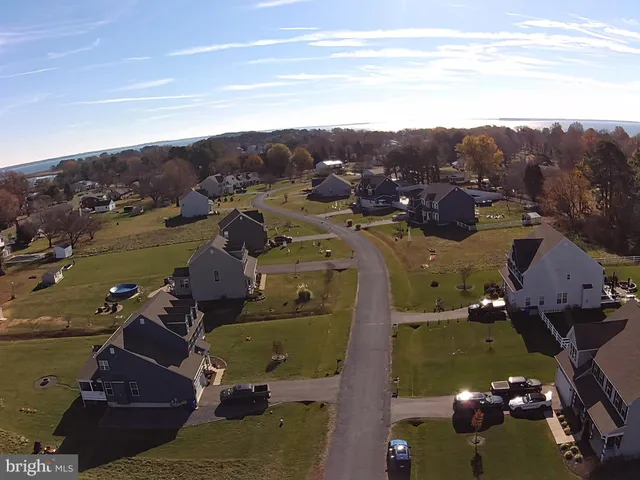 an aerial view of a house with a mountain