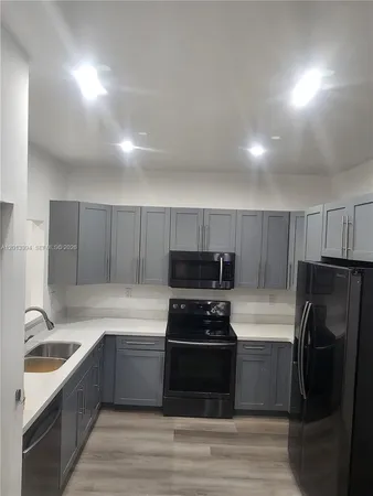 a kitchen with a refrigerator and a sink