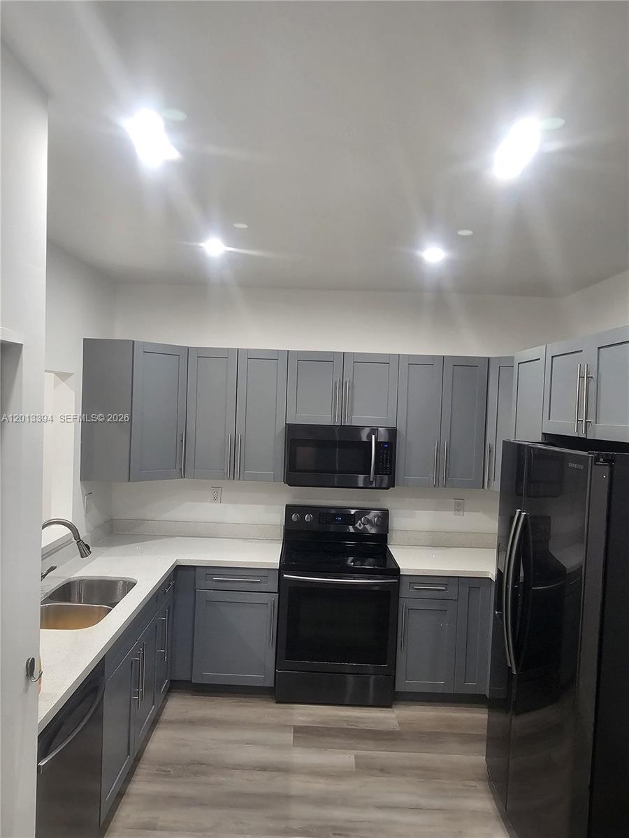 4010 Tree Top Road, Unit 4010 Cooper City, FL 33026 - Photo 1 of 12 a kitchen with a refrigerator and a sink