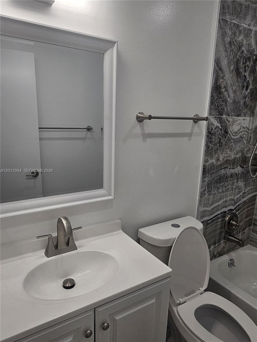 4010 Tree Top Road, Unit 4010 Cooper City, FL 33026 - Photo 4 of 12 a bathroom with a sink and a toilet
